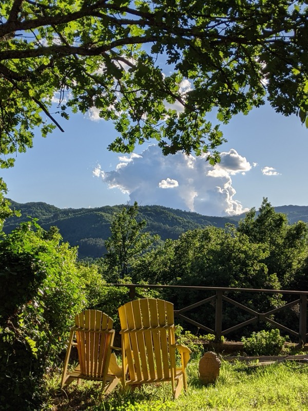 Yellow Adirondack chairs overlooking the hills