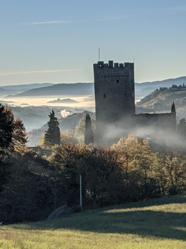 Medieval tower rising from morning mist